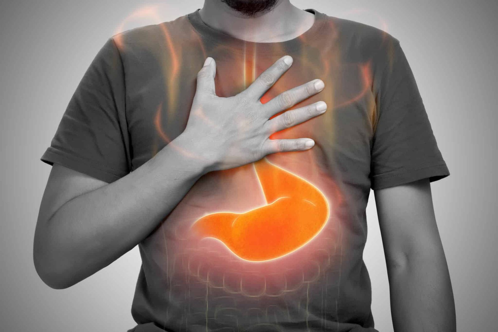 A man burning sensation in chest from acid reflux on gray background. Downloader.la 659a09248a3b5